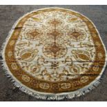 A large English classical design carpet, the ivory field with a cntral lobed pole medallion,