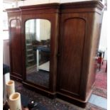 A Victorian mahogany breakfront triple wardrobe with central mirrored door, width 250cm.