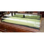 An early 20th century counter top display case with bowed glass and a pair of mirrored,