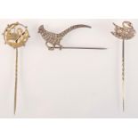 A Victorian Aesthetic Movement silver gilt pin with a heron and a continental silver pin with a