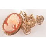 A gold carriage charm and a gold mounted cameo pendant/brooch.