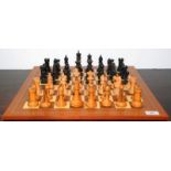 A Staunton pattern chess set marked with crowns to one white rook and one black rook,