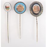 Three micromosaic silver pins, each showing a ruin.