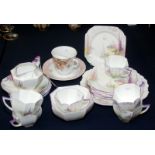 A Shelley octagonal section part tea service pattern number C1911 with hollyhocks and a fountain in