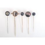 A banded agate pin set a miniature compass together with four other banded agate pins.