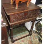 A 17th century oak boarded box, the front carved, associated stand, width 67cm.