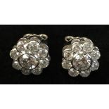 A pair of good diamond and platinum cluster earrings, each with a central stone of approximately .