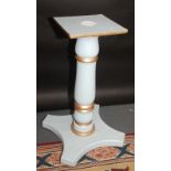 A painted wooden pedestal.