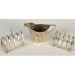 A pair of small toast racks and an embossed small milk jug, 4.5oz.