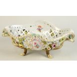 A Meissen porcelain floral encrusted pierced oval basket with naturalistic handles and feet,