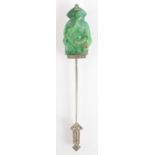A 1920s French Jabot pin in white gold with a carved jade seated figure finial set with rose cut