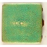 A silver shagreen covered compact.