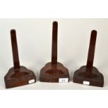 A set of three mahogany lead weighted dish stands, each with carved shaped base.