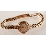 A ladies Omega gold cased wrist watch on gold bracelet. Total weight 19.
