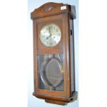 A German pre war wall clock in oak case.