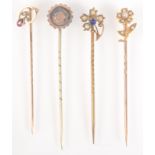 A gold mounted flower pin with pearls and a sapphire, one other flower form gold pin,