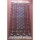 A Pakistan rug, the blue field with eight rows of two octagonal medallions,