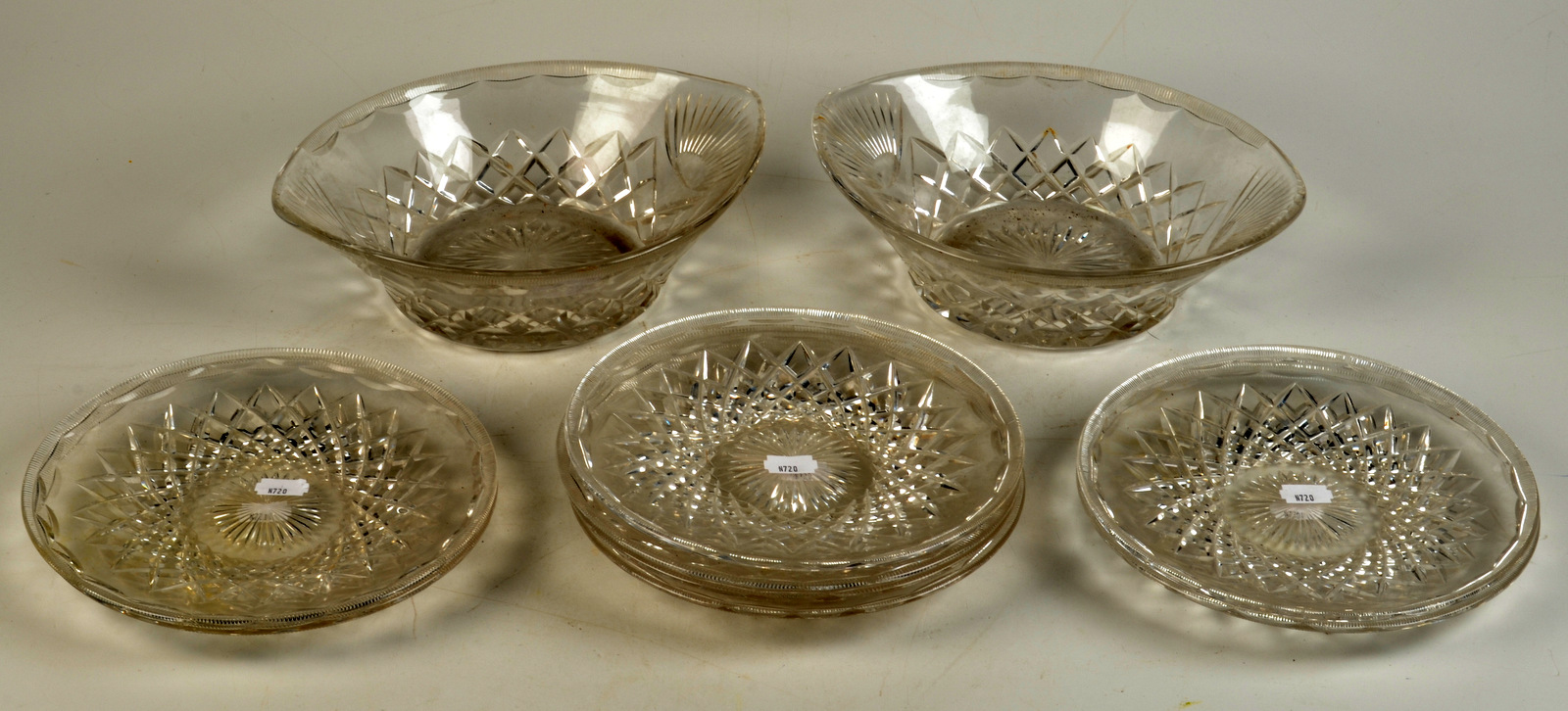 A pair of cut glass eliptical bowls each 27cm wide, together with eight matching 21cm plates.