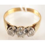 An 18ct. gold three stone diamond ring.