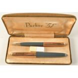 A Parker 51 grey and engine turned gilt fountain pen cased with matching pencil.