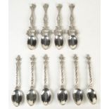 A set of six Indian spoons with deity finials and snake intertwined stems, apparently silver,