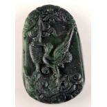 A Chinese dark spinach jade style pendant with a crane, height 5cm.