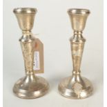 A pair of filled silver candlesticks.