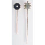 A gold stick pin set with cat's eye surrounded by eight rose cut diamonds,