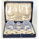 A cased set of six Wedgwood coffee cans and saucers with classical and floral decoration,