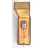 A gold pin the hard stone rectangular finial carved with a hunting group, boxed.