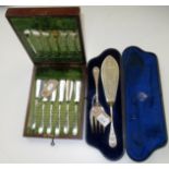A pair of well engraved fish servers, cased,
