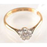 An 18ct. yellow gold and platinum solitaire diamond ring, the stone of approximately .5 ct spread.