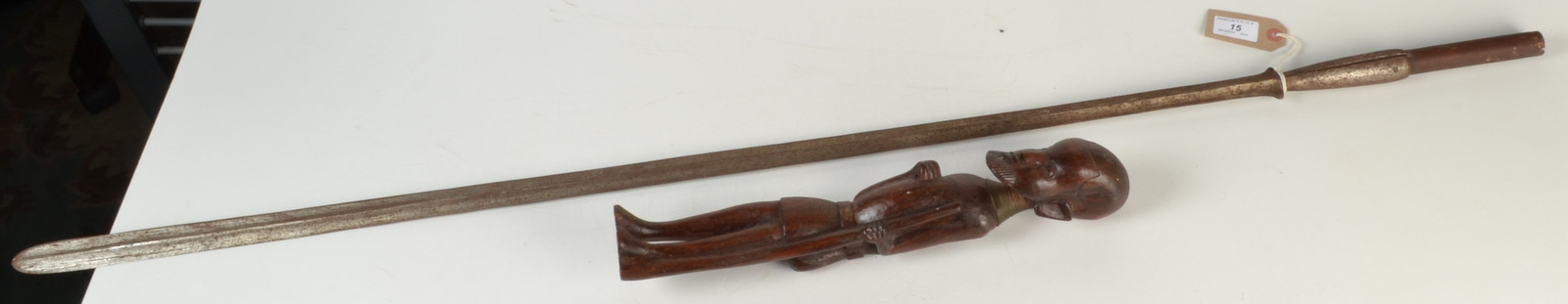 A Massai lion spear, length 113.5cm, together with an African carved wood figure.