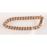 A 9ct. curb link bracelet, 34.5g.