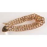 A 9ct gold hollow curb link double strand bracelet with padlock clasp, 12.7g.