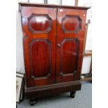 A Victorian panelled mahogany 2 door cupboard on turned feet, formerly housing a commercial safe