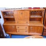 A 1970's teak and leaded glass cocktail sideboard 151cm wide 128cm high