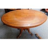 A late Victorian cross-banded walnut oval tilt-top salon table 117cm wide