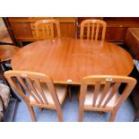 A teak dining suite, comprising oval extending table with integral leaf, 4 matching chairs by Sakol