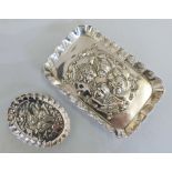 An Edwardian silver rectangular trinket dish, Chester 1903, embossed with live cherubs and an oval