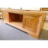 An oak TV stand with twin cupboards