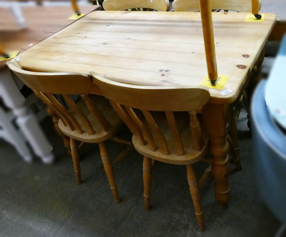 A pine kitchen table, together with four matching pine chairs