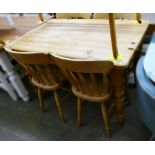 A pine kitchen table, together with four matching pine chairs