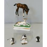 Royal Doulton; a set of three penguins, K20, K23 and K24, a Royal Doulton figure of a pony feeding