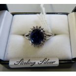 A sterling silver blue stone and cubic zirconia ring