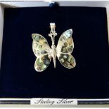 A sterling silver butterfly pendant set with South American shell