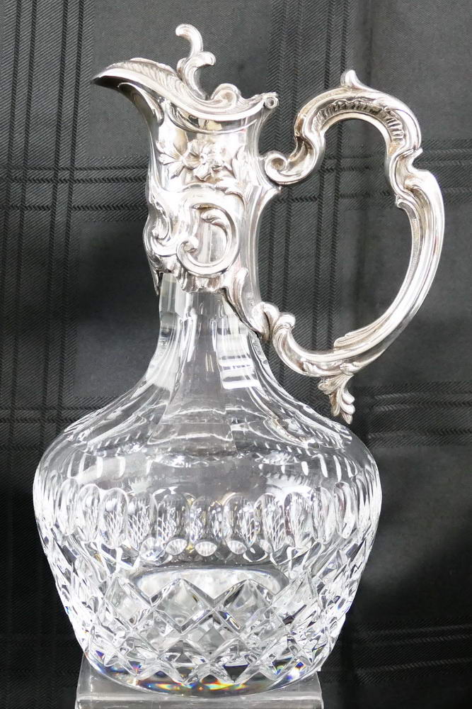 A clear glass claret jug, of mallet shaped form with deep cut body and star cut base, the slice