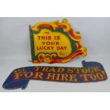 A painted and gilded wooden fairground sign, of two-sided assymetrical form with scrolling edges
