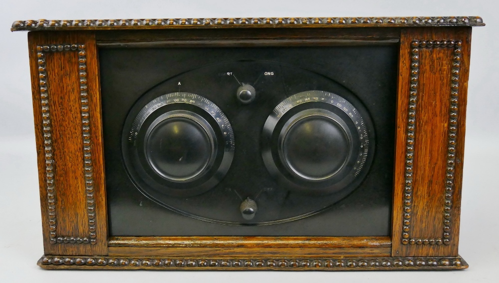 A three valve table top radio, probably by Graves, in beaded wooden case with hinged lid, 42cm