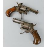 A pair of 7mm pin fire revolvers, each with split walnut stock, folding trigger and later ejector,